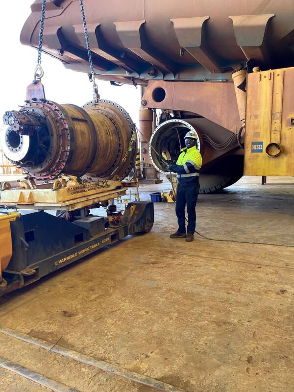 Final drive assembly being lifted out from under a haul truck in the workshop