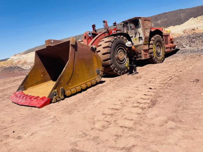 Underground loader parked on red dirt